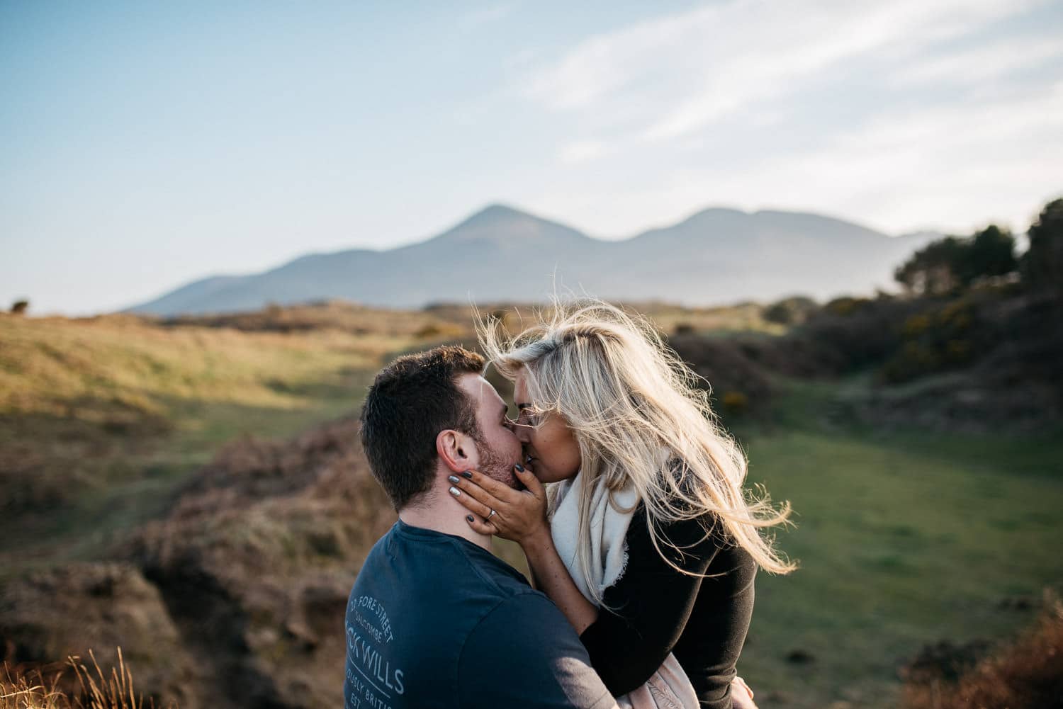 couple kissing in front of mountains Engagement Photography Northern Ireland 