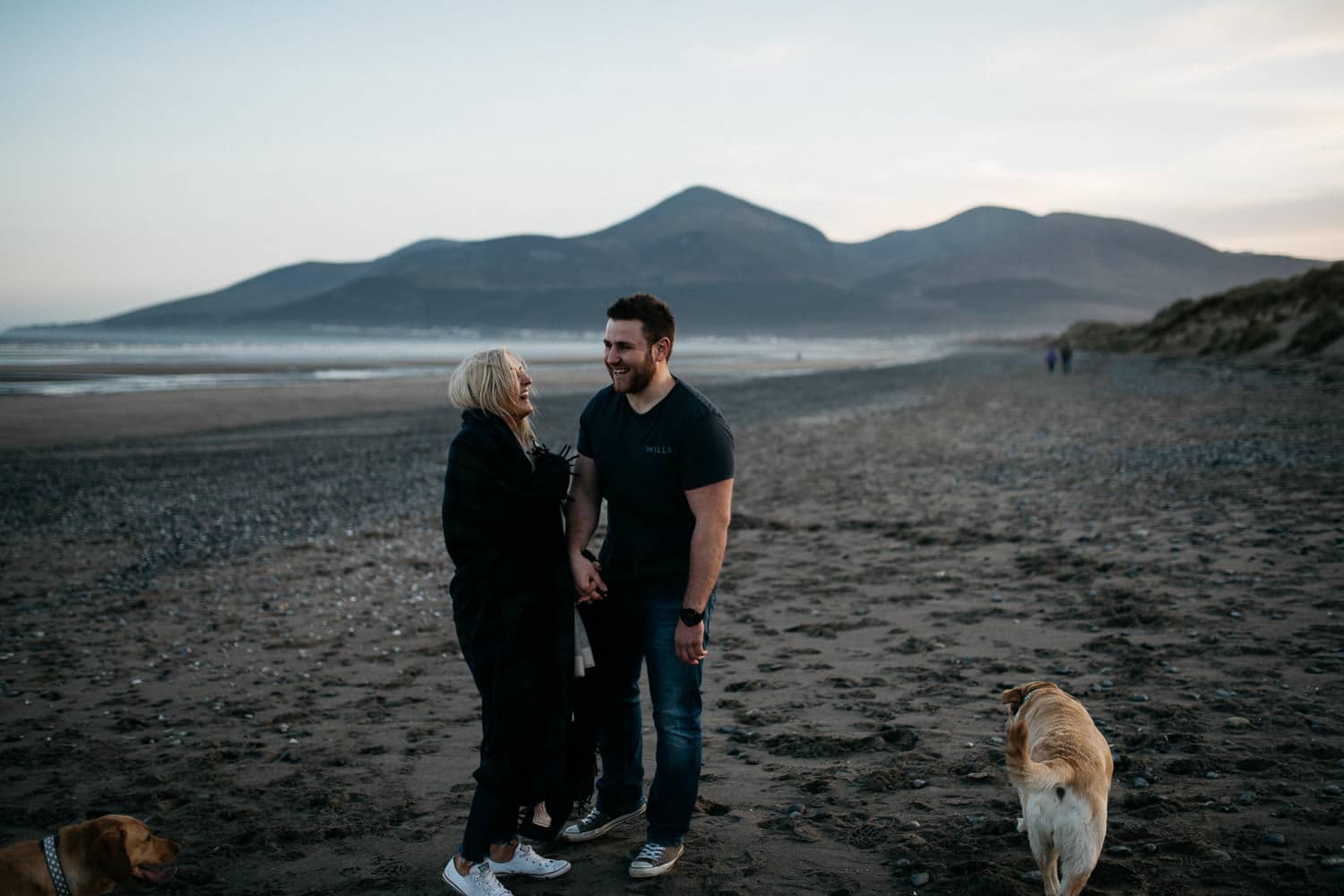 couple laughing with dogs in front of sleeve Donald 