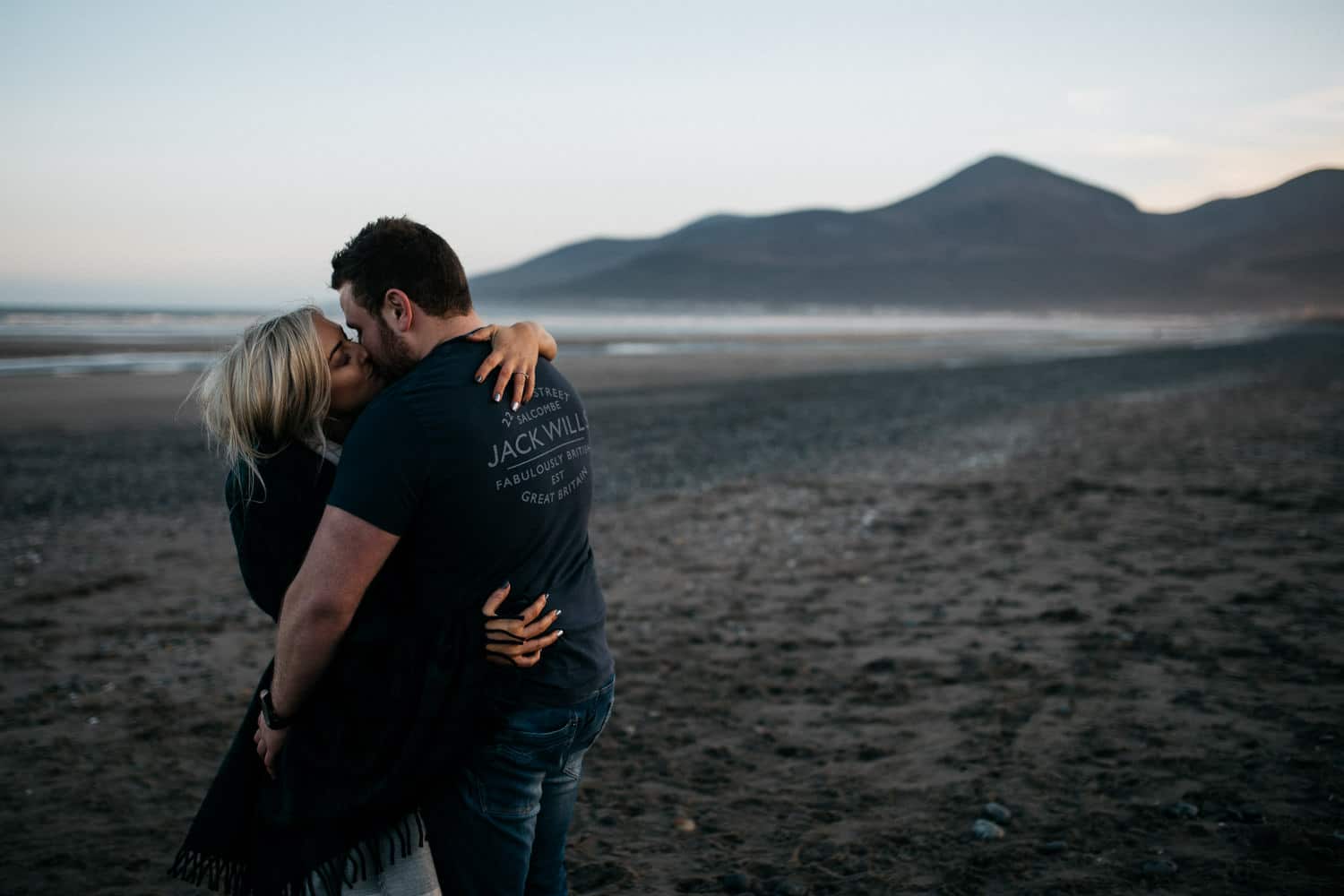 kissing in front of sleeve Donald engagement photography belfast