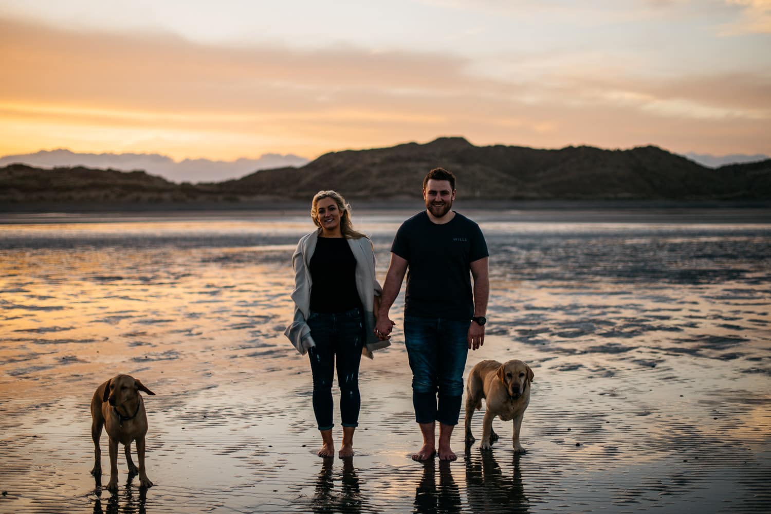 couple standing in front of sunset