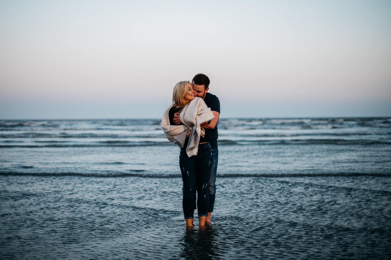 couple kissing in the water at sunset Engagement Photography Belfast