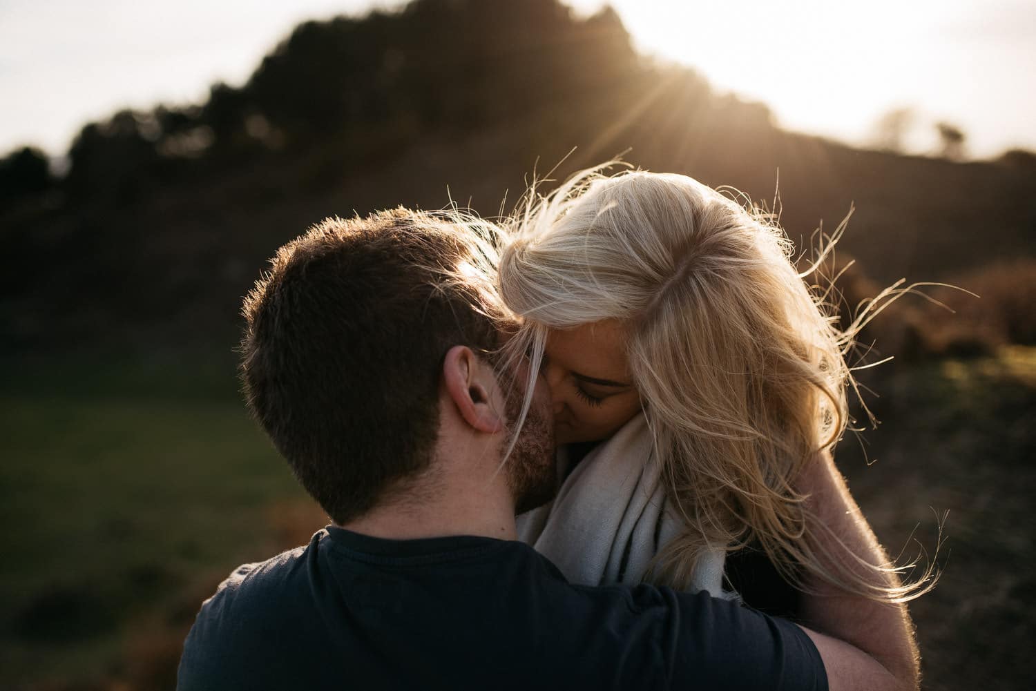 couple kissing and sun coming through Engagement Photos Belfast