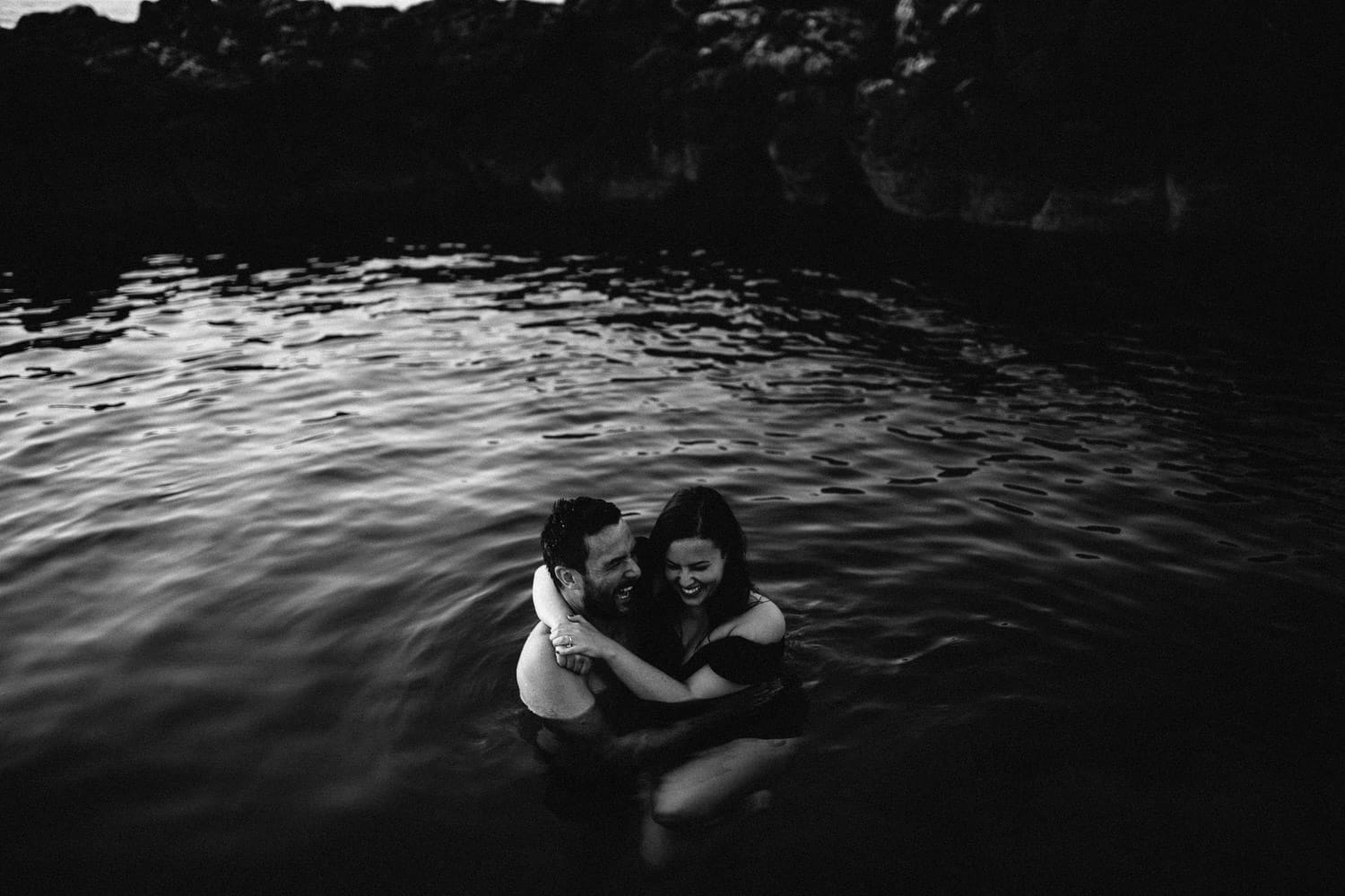 couple laughing in the water with black and white Engagement Photography Northern Ireland