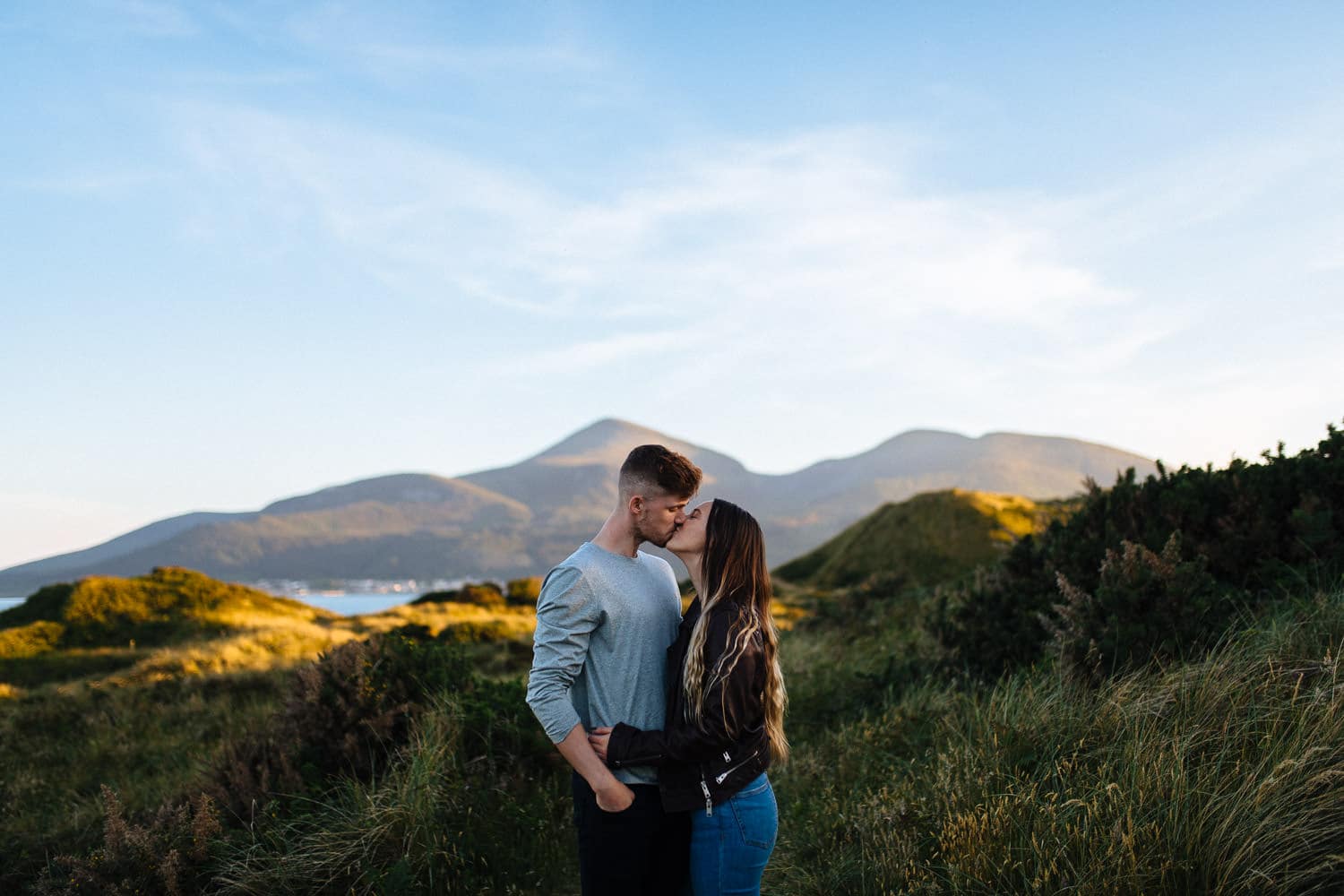 couple kissing in front of a mountain Belfast Engagement Photography