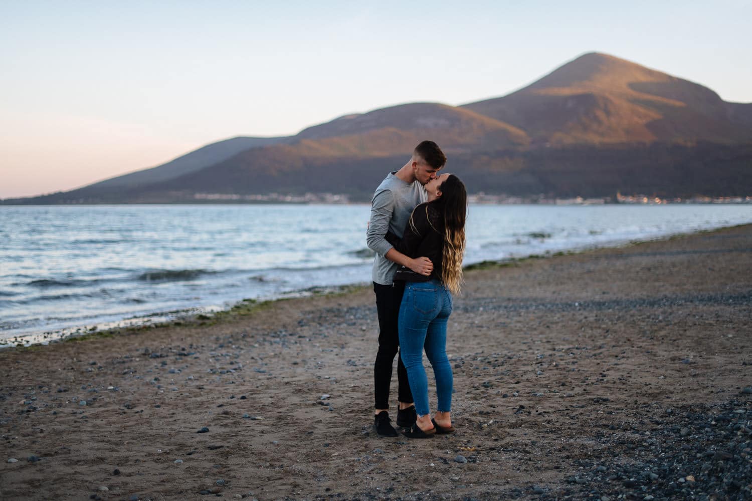 couple kissing in front of a mountain Belfast Engagement Photography