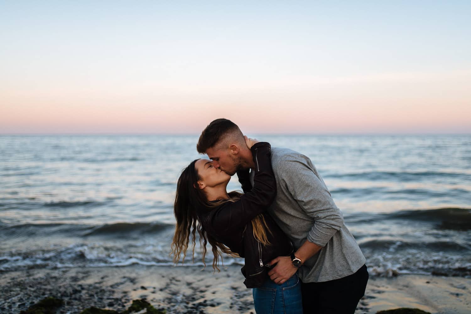 dipping kiss in front of the sea Belfast Engagement Photography