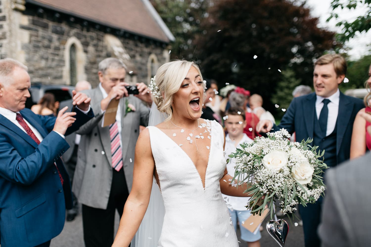 bride with confetti round her outside church Wedding Photos Northern Ireland