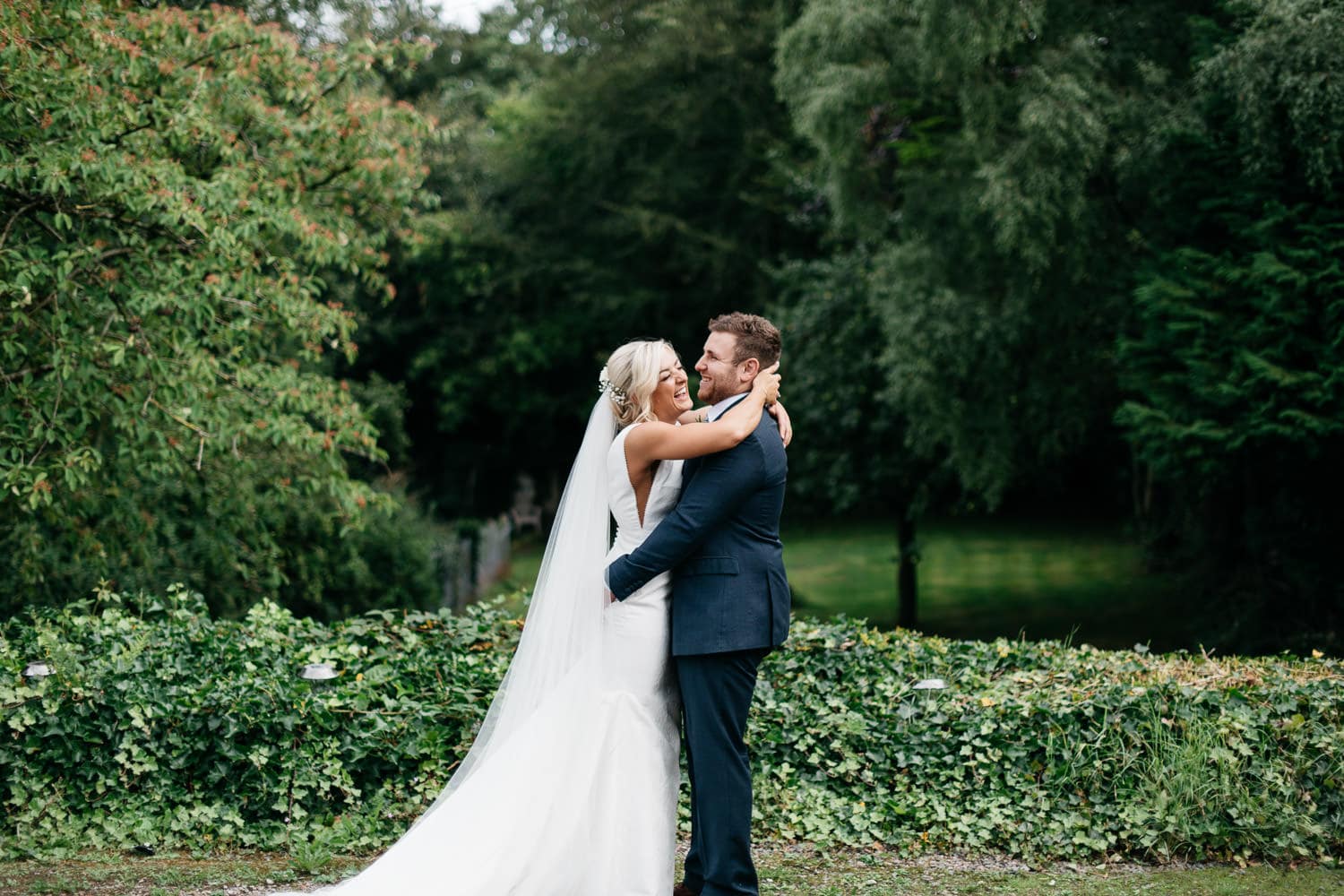 bride and groom laughing in garden Wedding Photographer Northern Ireland