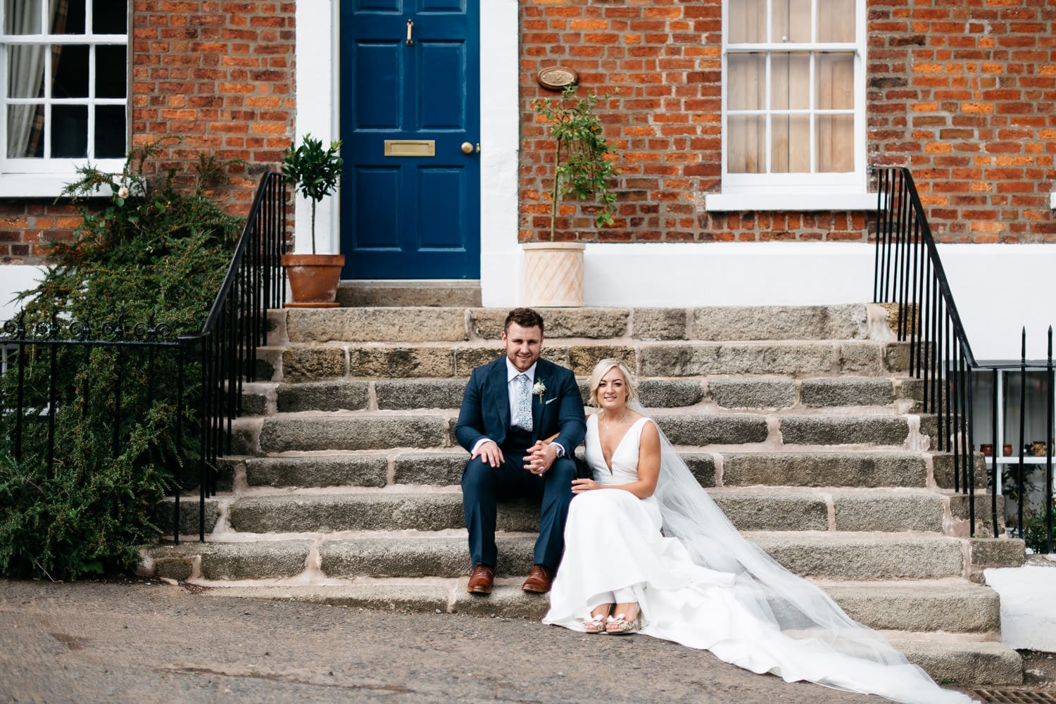 bride and groom sitting on steps Hillsborough Northern Ireland Wedding Photographer 