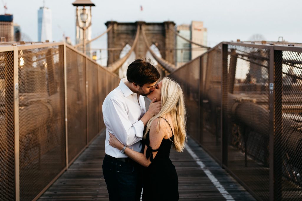 couple kissing on Brooklyn bridge New York Engagement photography