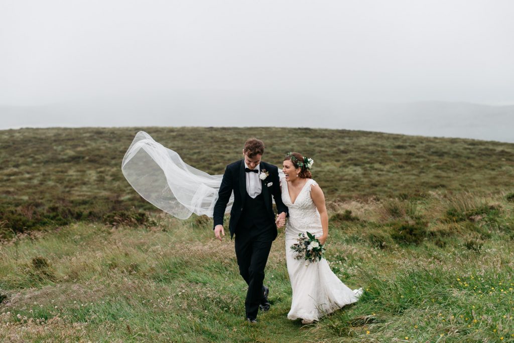 bride and groom walking in field dding photos Northern Ireland Wedding Photographers