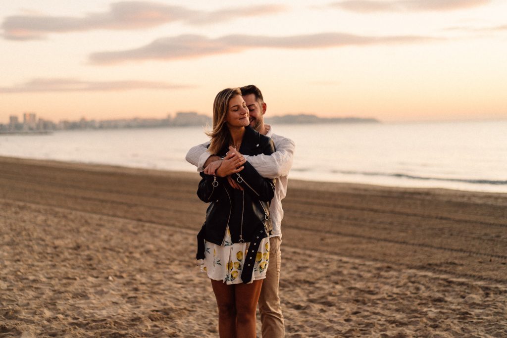 couple hugging on the beach at sunrise Wedding Photographers Barcelona