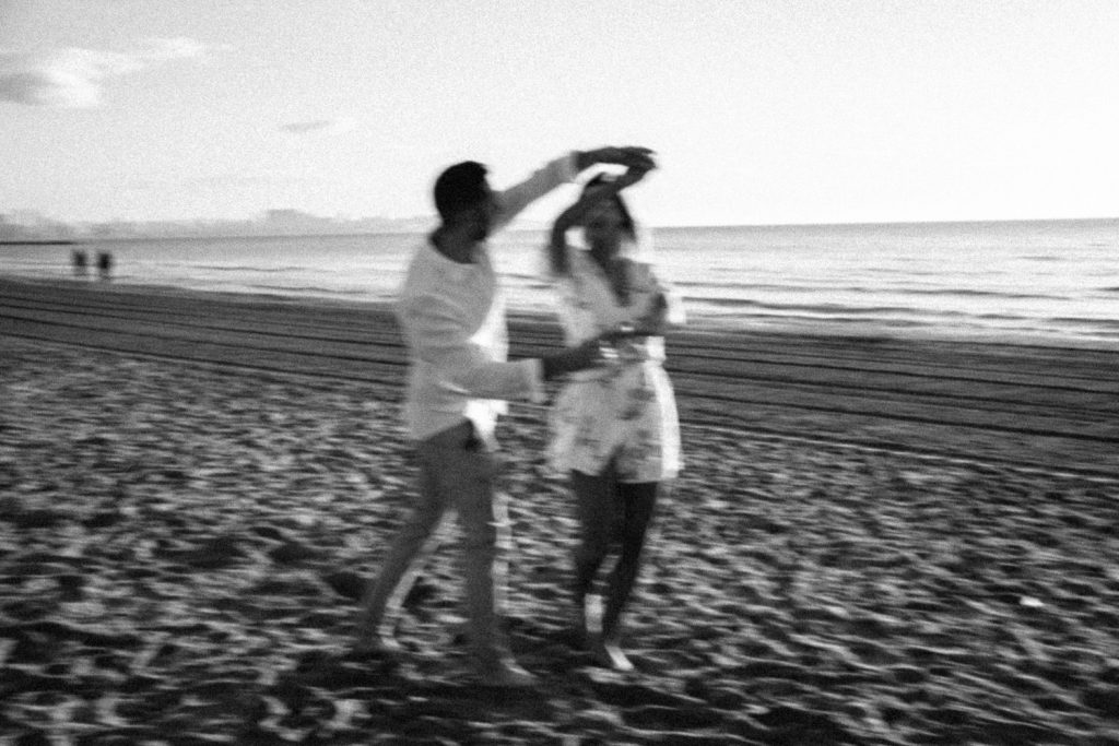 couple dancing on the beach black and white Wedding Photographers Barcelona