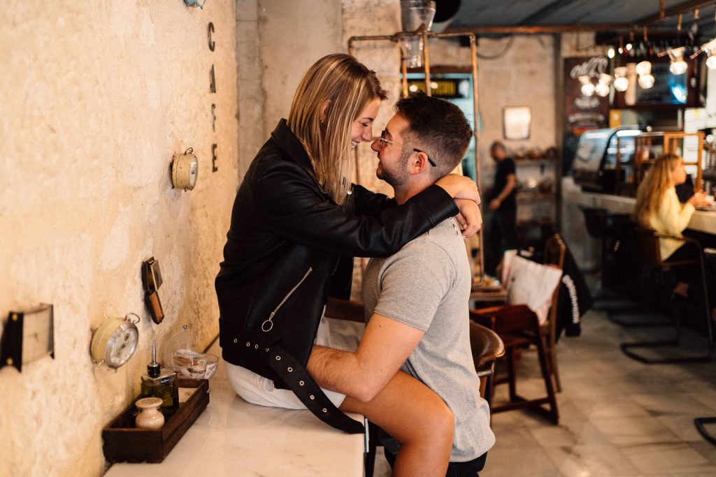 couple being intimate in coffee shop Wedding Photographers Barcelona