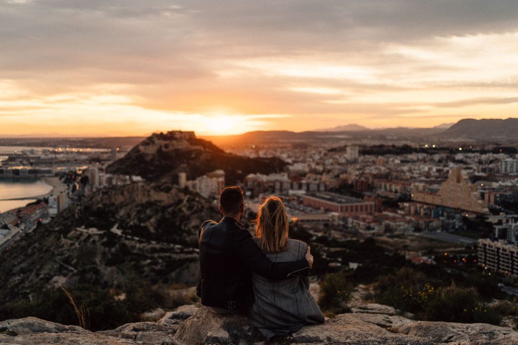 couple watching sunset couple hugging and laughing at sunset Wedding Photography Barcelona