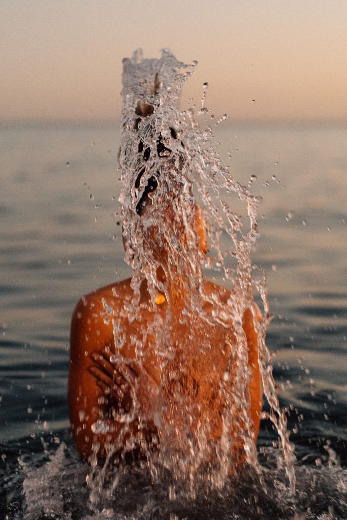 girl flicking her hair back in water 