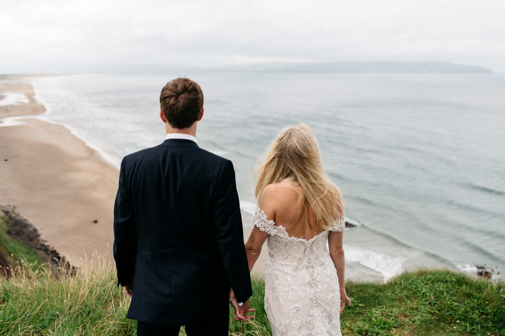 couple looking out to sea after wedding at Mussenden temple at their wedding Elopement Photographer Ireland