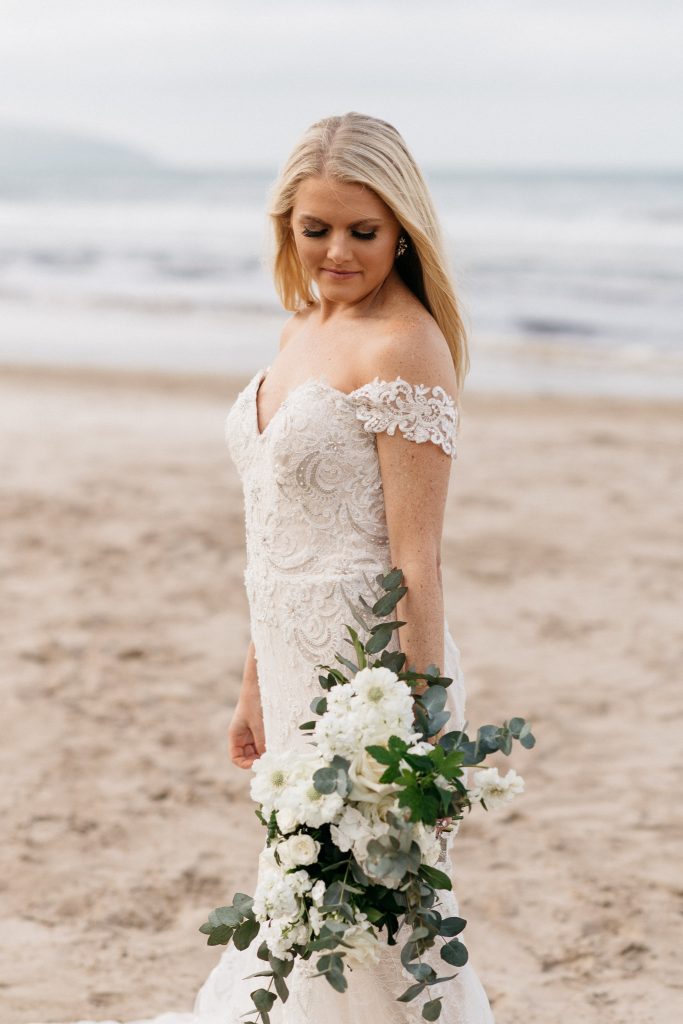 bride holding flowers on the beach Elopement Photographer Ireland