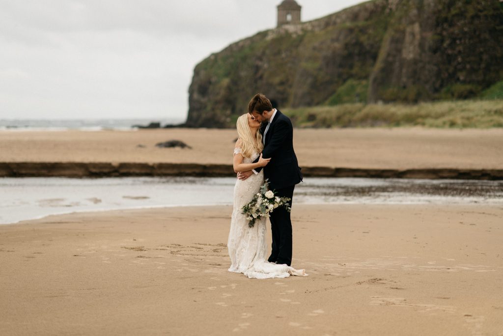 couple kissing on the beach Northern Ireland Elopement Photographers