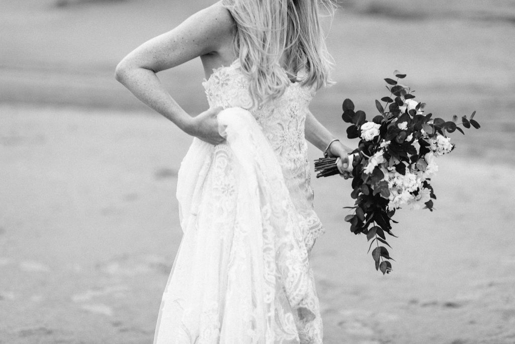bride holding up dress Northern Ireland Elopement Photographersblack and white