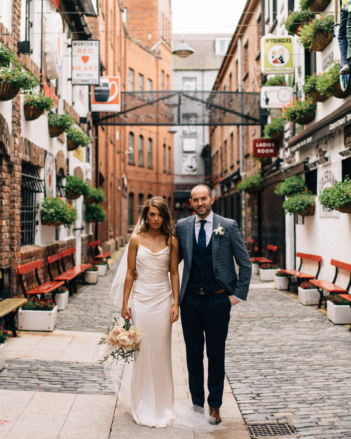 bride and groom standing outside Duek of York Belfast Wedding Merchant Hotel Photos