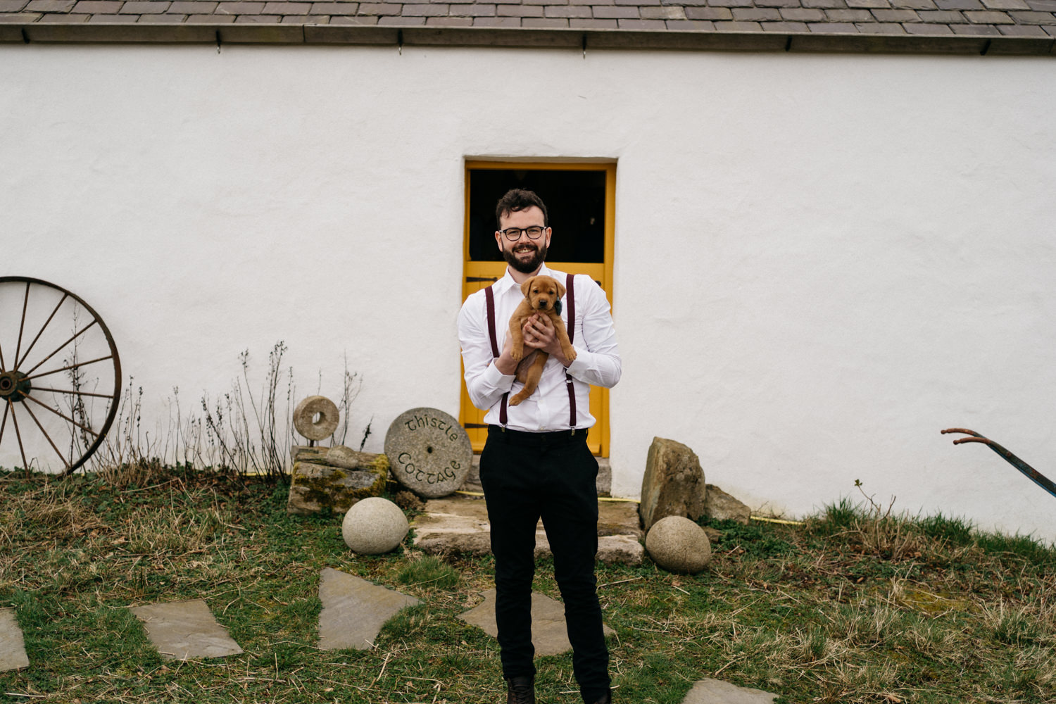 groom holding a puppyMourne Mountains Wedding Photography
