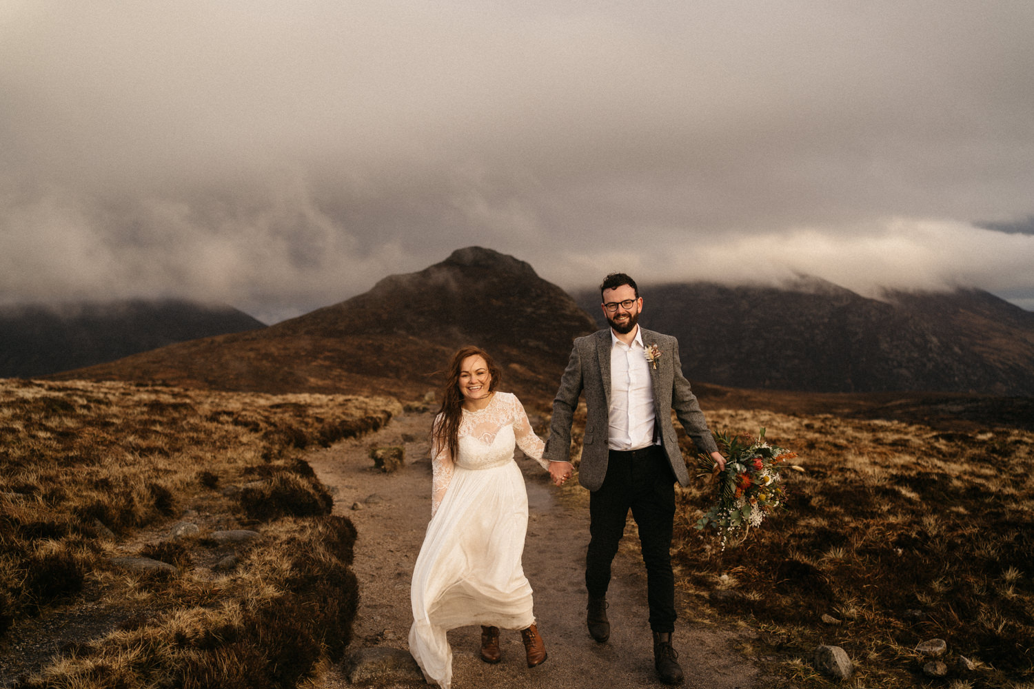 bride and groom walking holding hands Mourne Mountains Wedding Photography