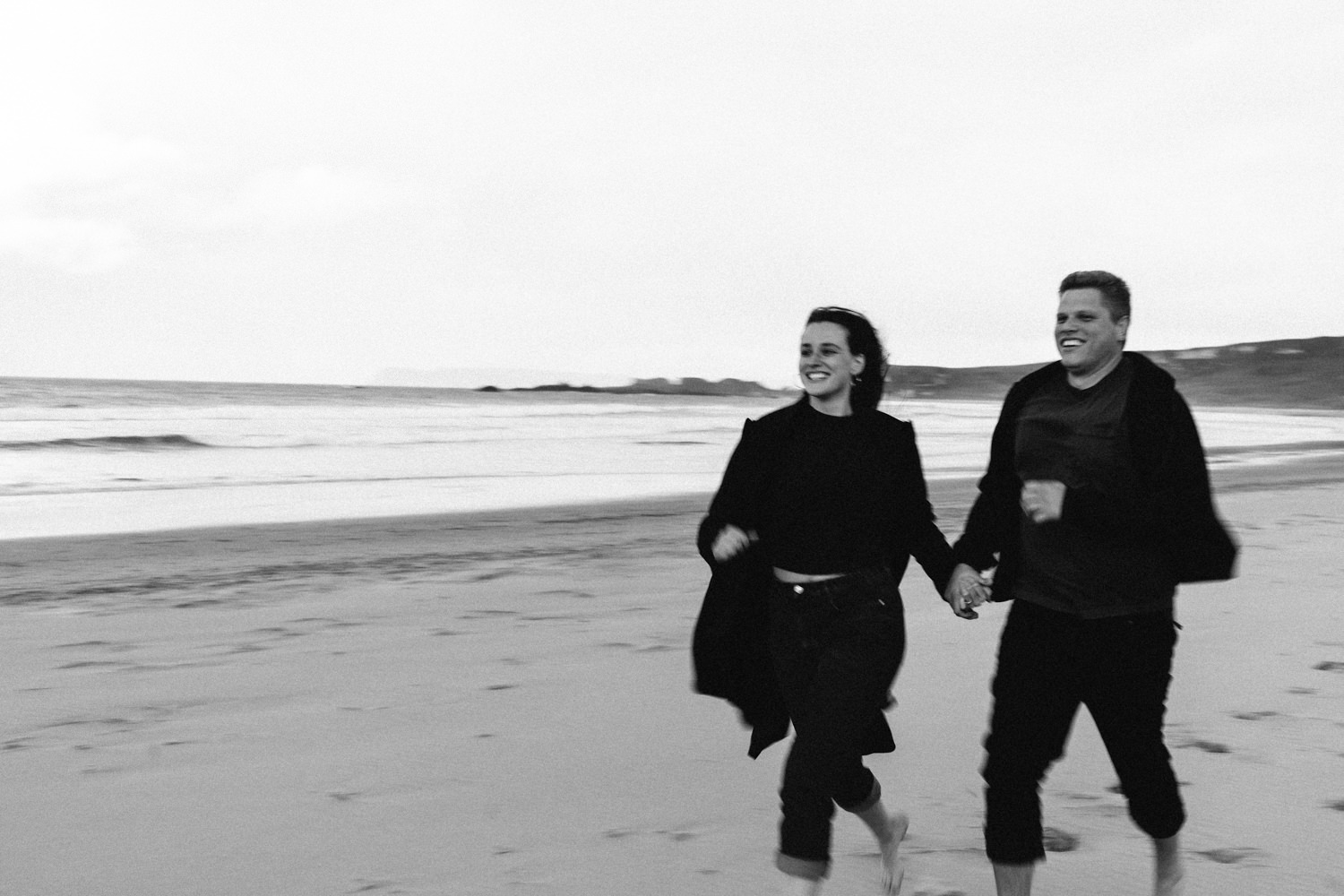 couple running on the beach black and white  Elopement Photographer - Couples Photographer