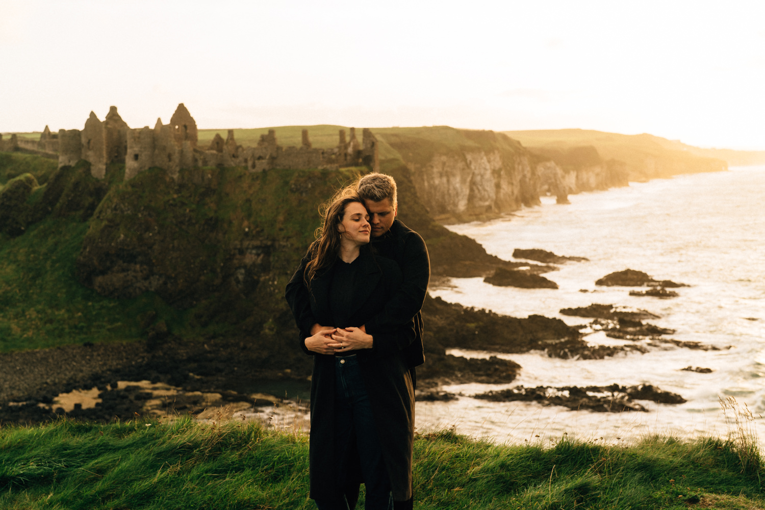 couple hugging at sunset at Dunluce Castle Northern Ireland Elopement Photographer