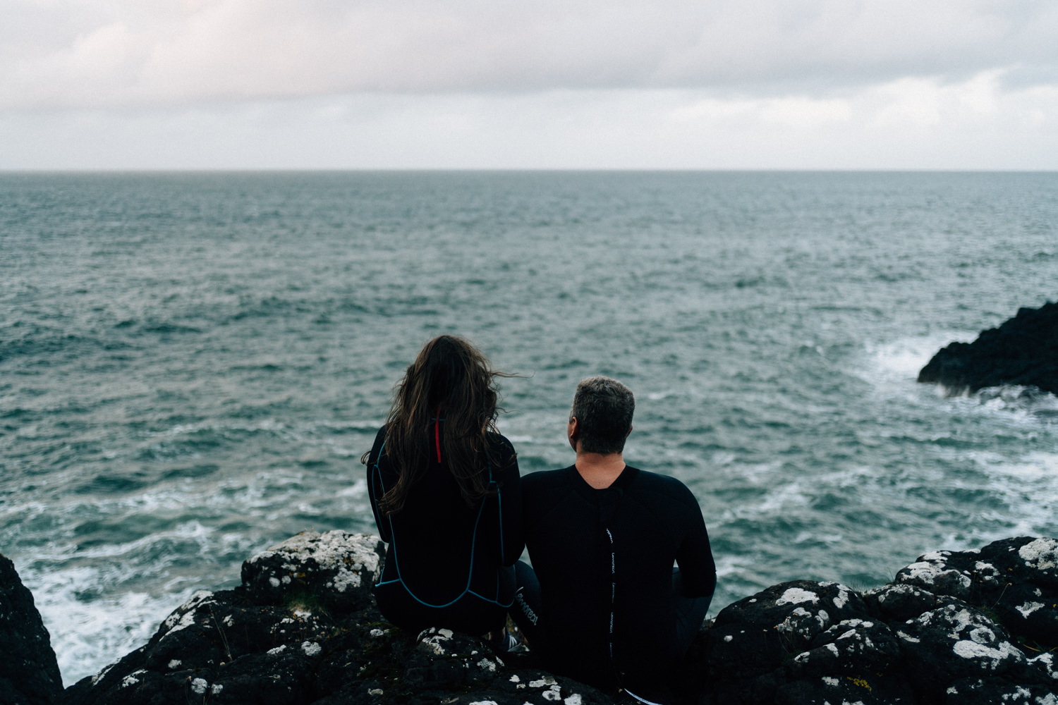 couple looking off to the Irish Sea  Elopement Photographer - Couples Photographer