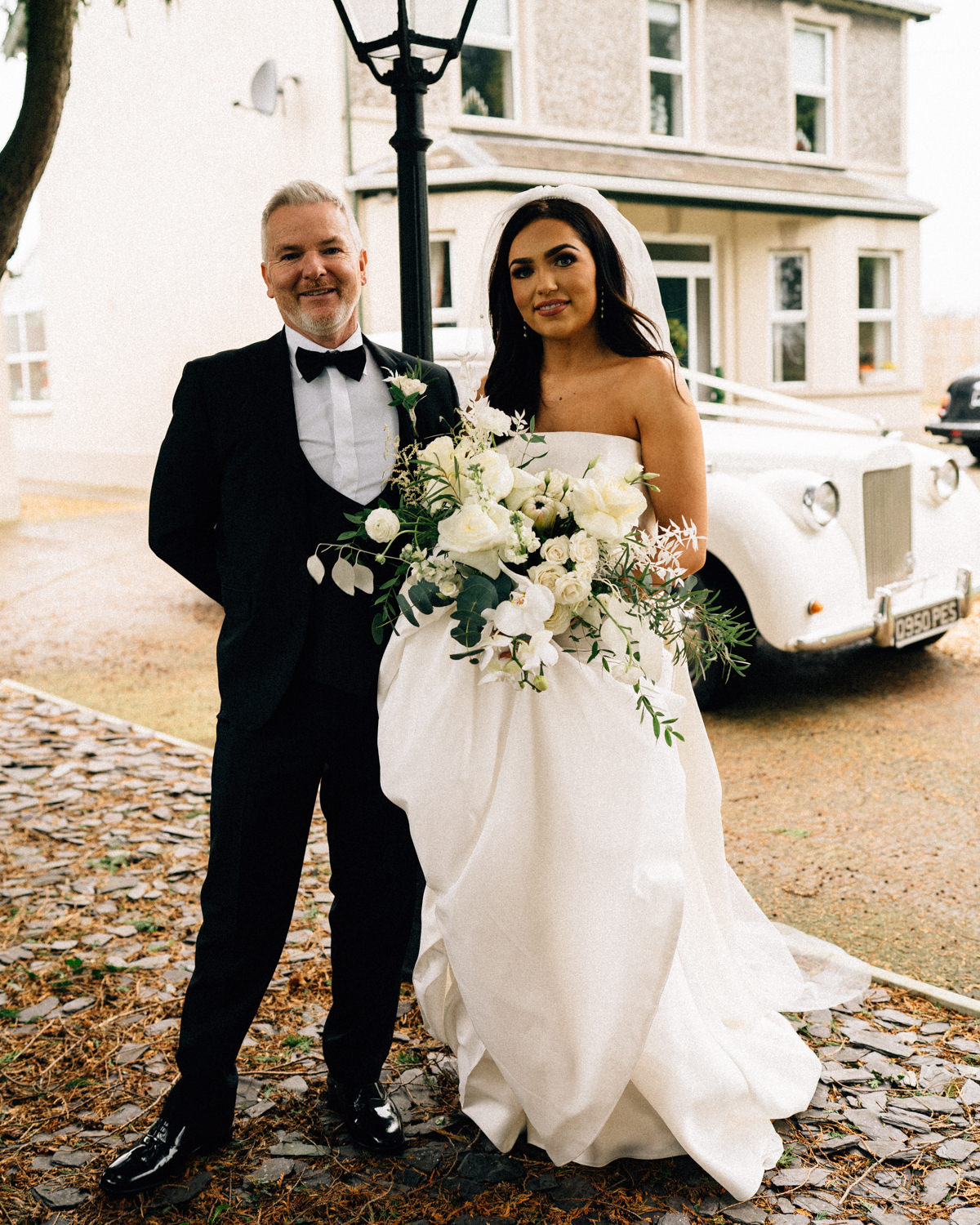 bride with her father outside their family home Castle Leslie Wedding Photos