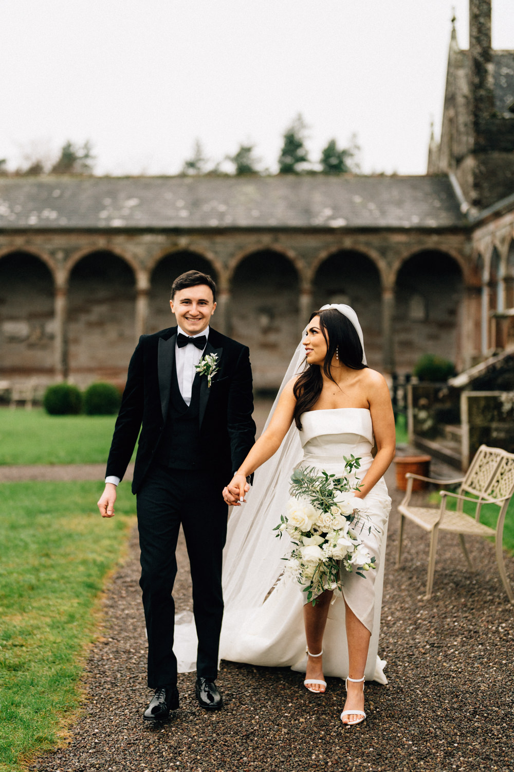 groom with his bride walking and laughing Castle Leslie Wedding Photos