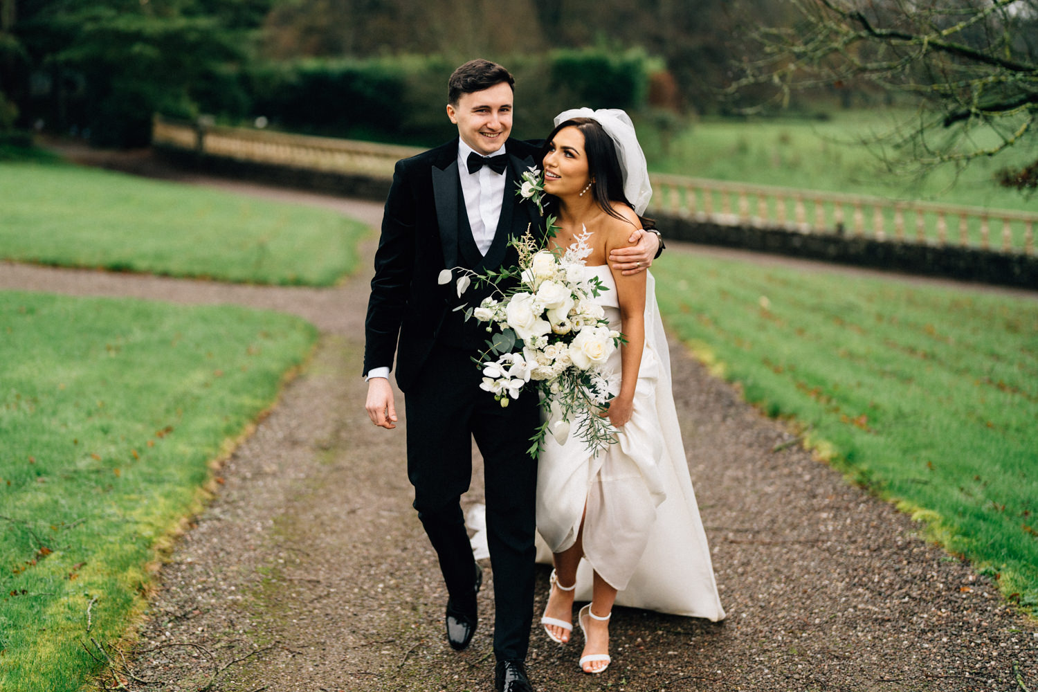 bride and groom walking and laughing Castle Leslie Wedding Photos