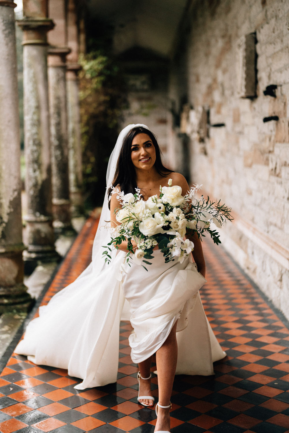 bride walking with her flowers 