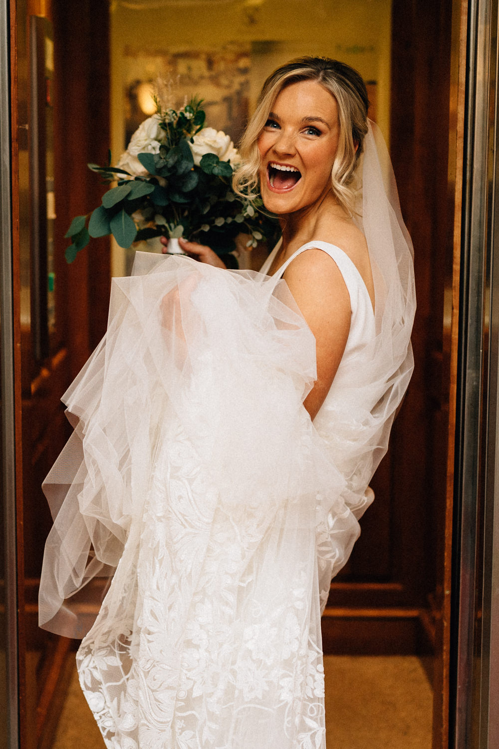 bride getting in the lift laughing Weddings at Killruddery House