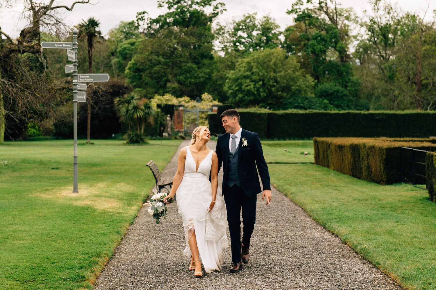 bride and groom walking and laughing Weddings at Killruddery House