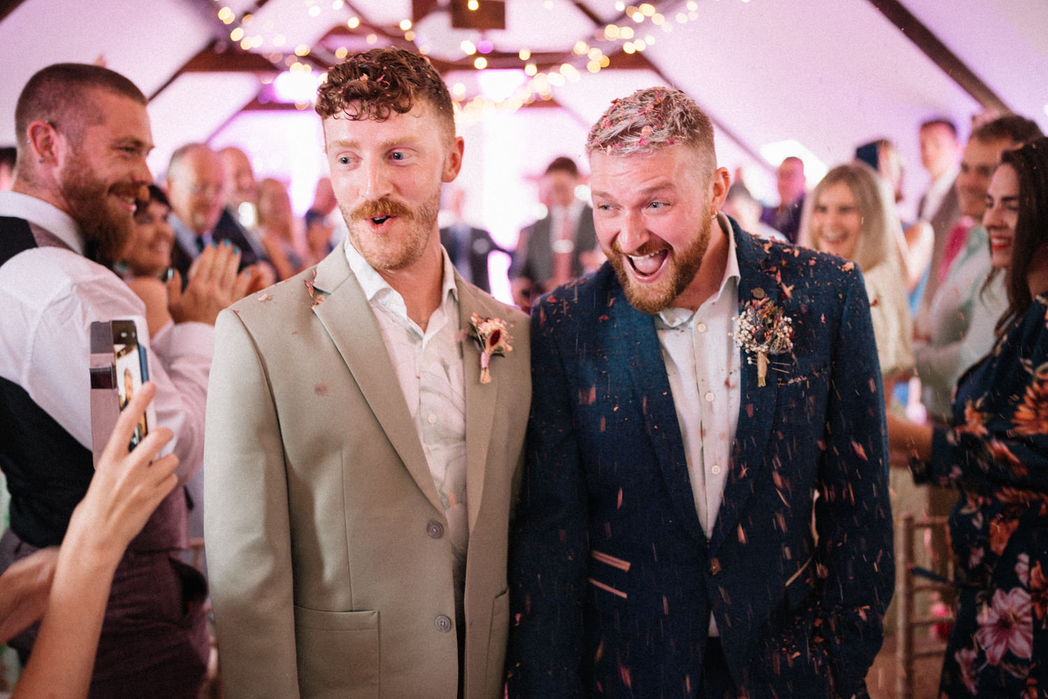 grooms walking down the aisle with confetti  LGBTQ Wedding Photographer Ireland