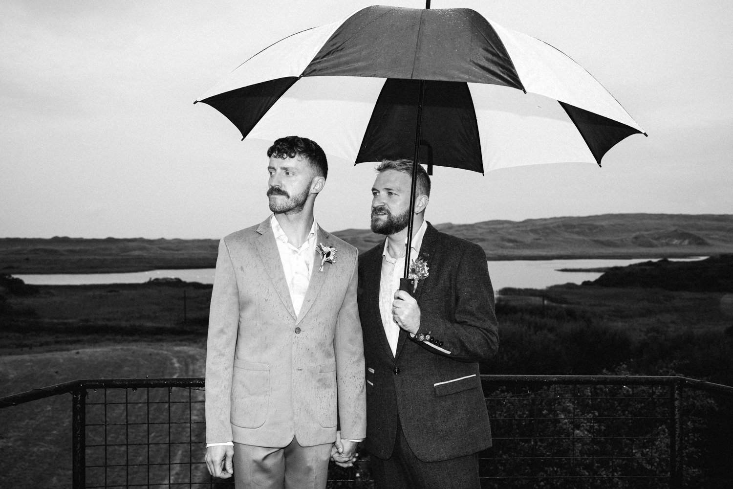 grooms posing with umbrella gay wedding LGBTQ Wedding Photographer Ireland