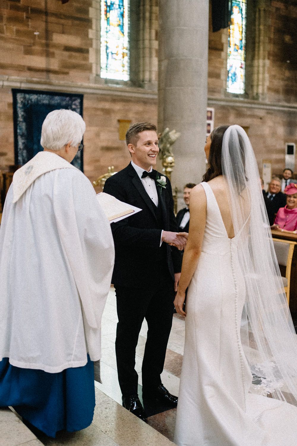 bride-and-groom-exchange-vows-st anne's-cathedral-belfast-Belfast-Wedding-Photographer