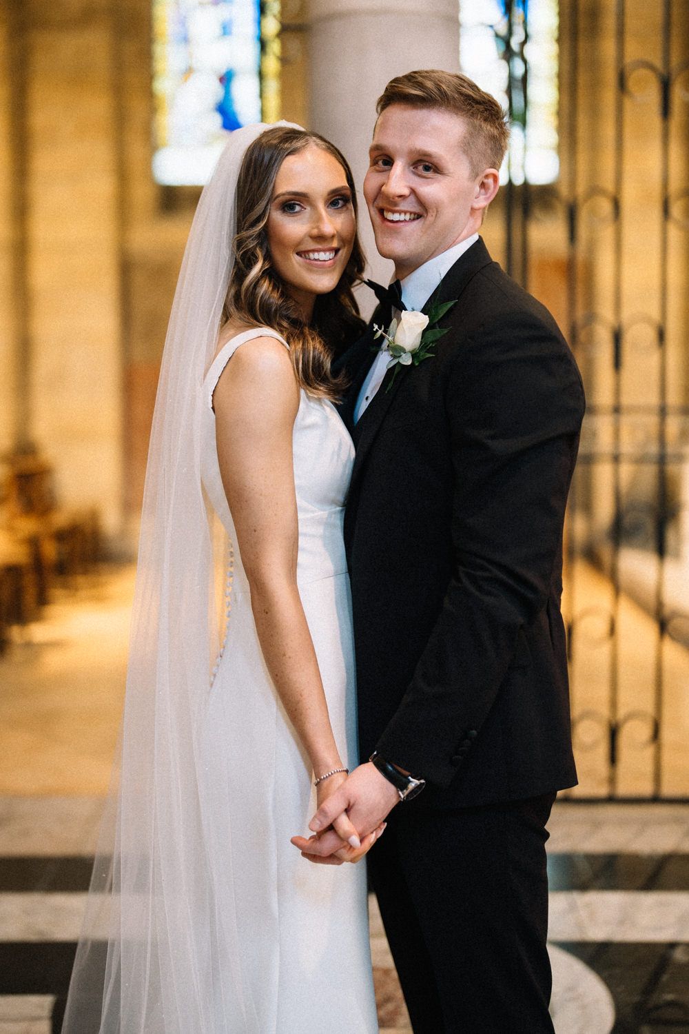 bride-and-groom-holding-hands-st anne's-cathedral-belfast-Belfast-Wedding-Photographer