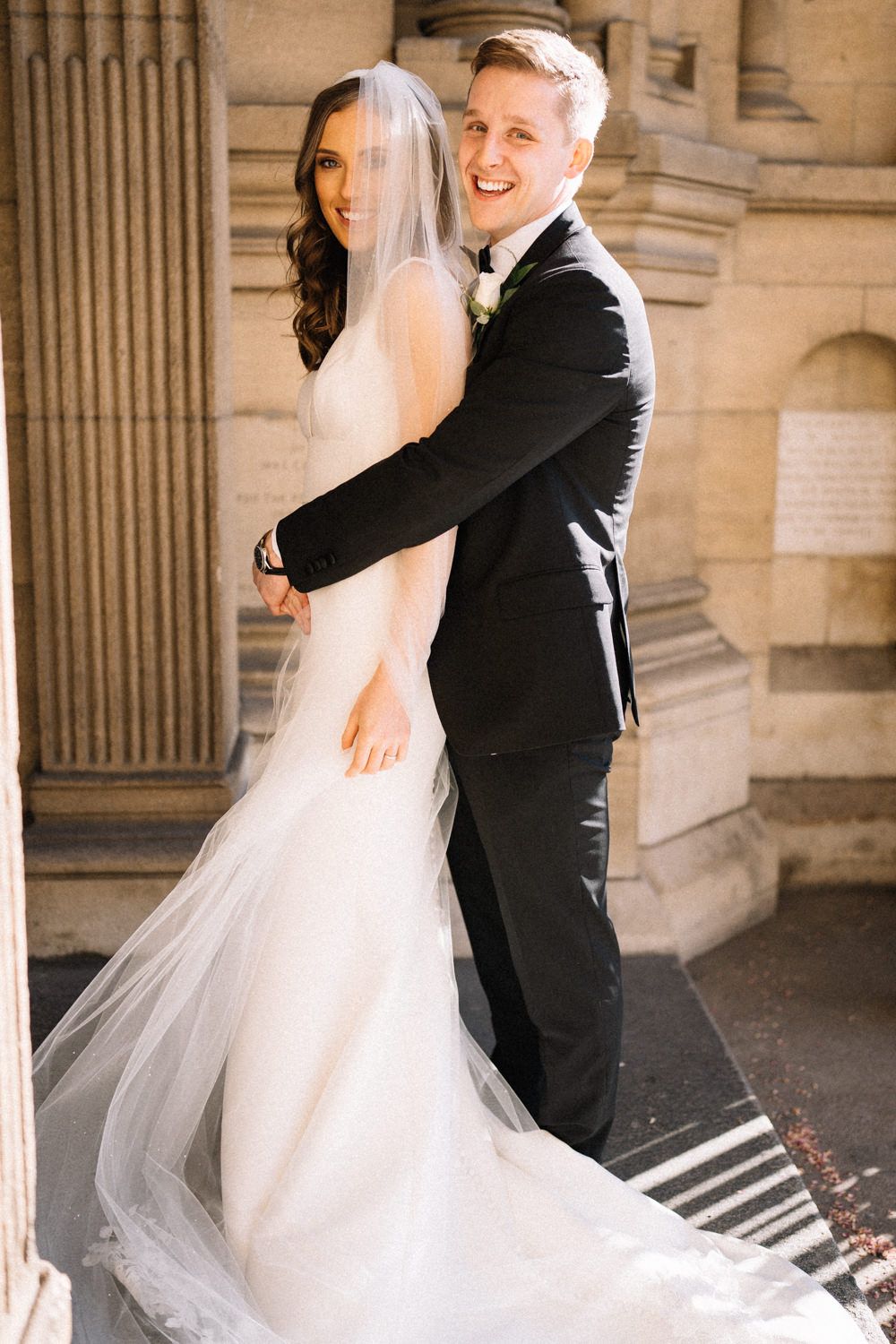 bride-and-groom-hugging-outside-st anne's-cathedral-belfast-Belfast-Wedding-Photographer