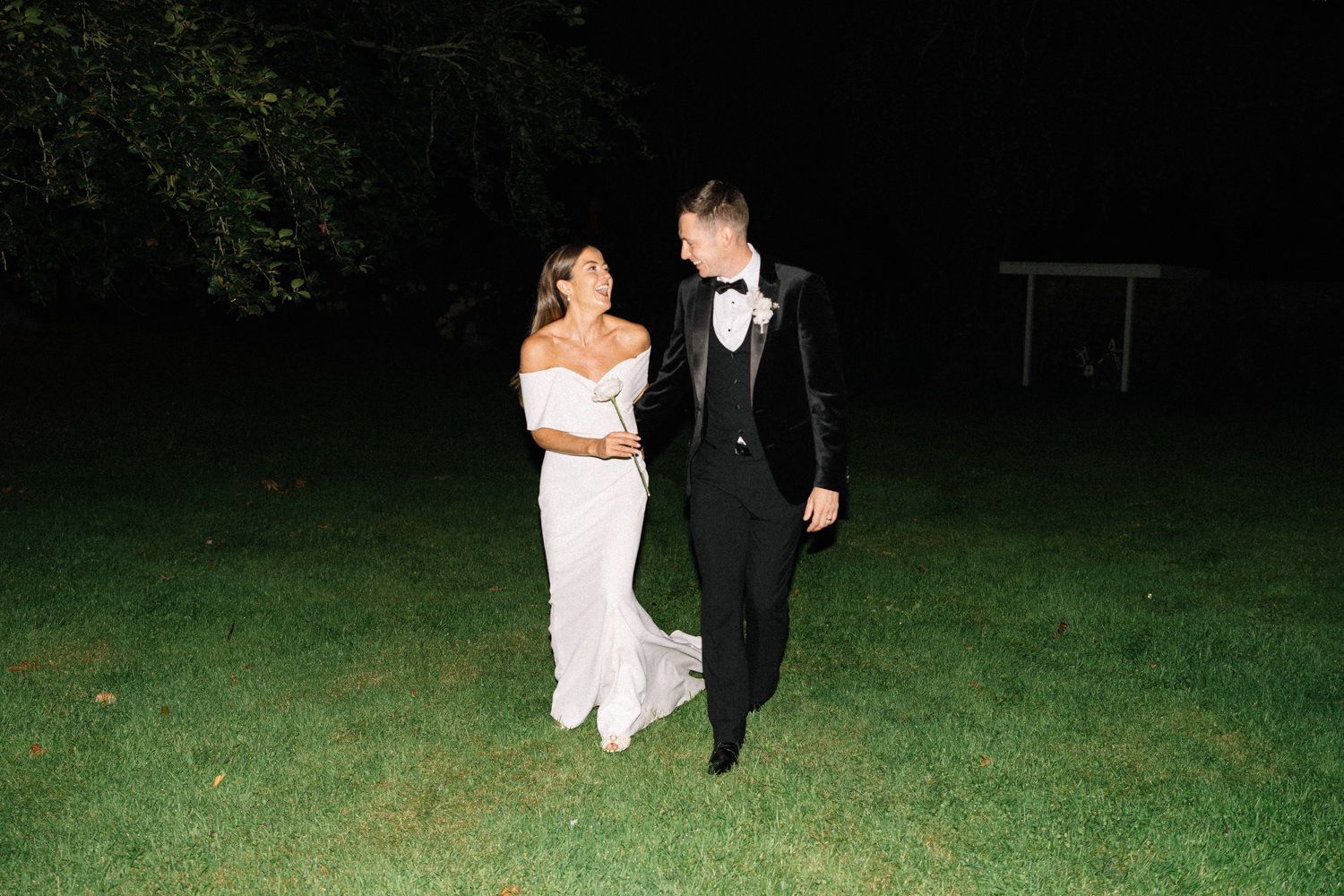 bride and groom laughing and walking at night tankardstown wedding