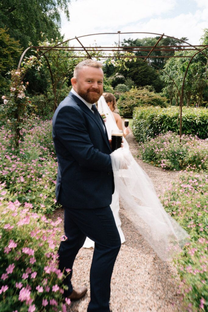 bride and groom walking in gardens Larchfield Estate Wedding Photos