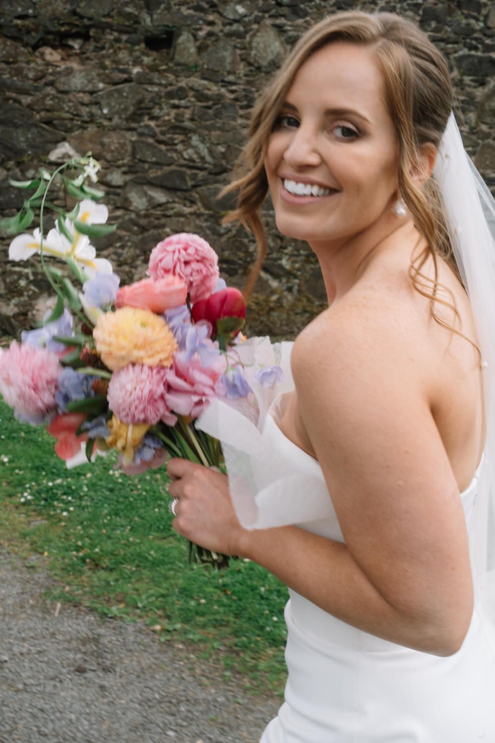 bride walking holding flowers Larchfield Estate Wedding Photos