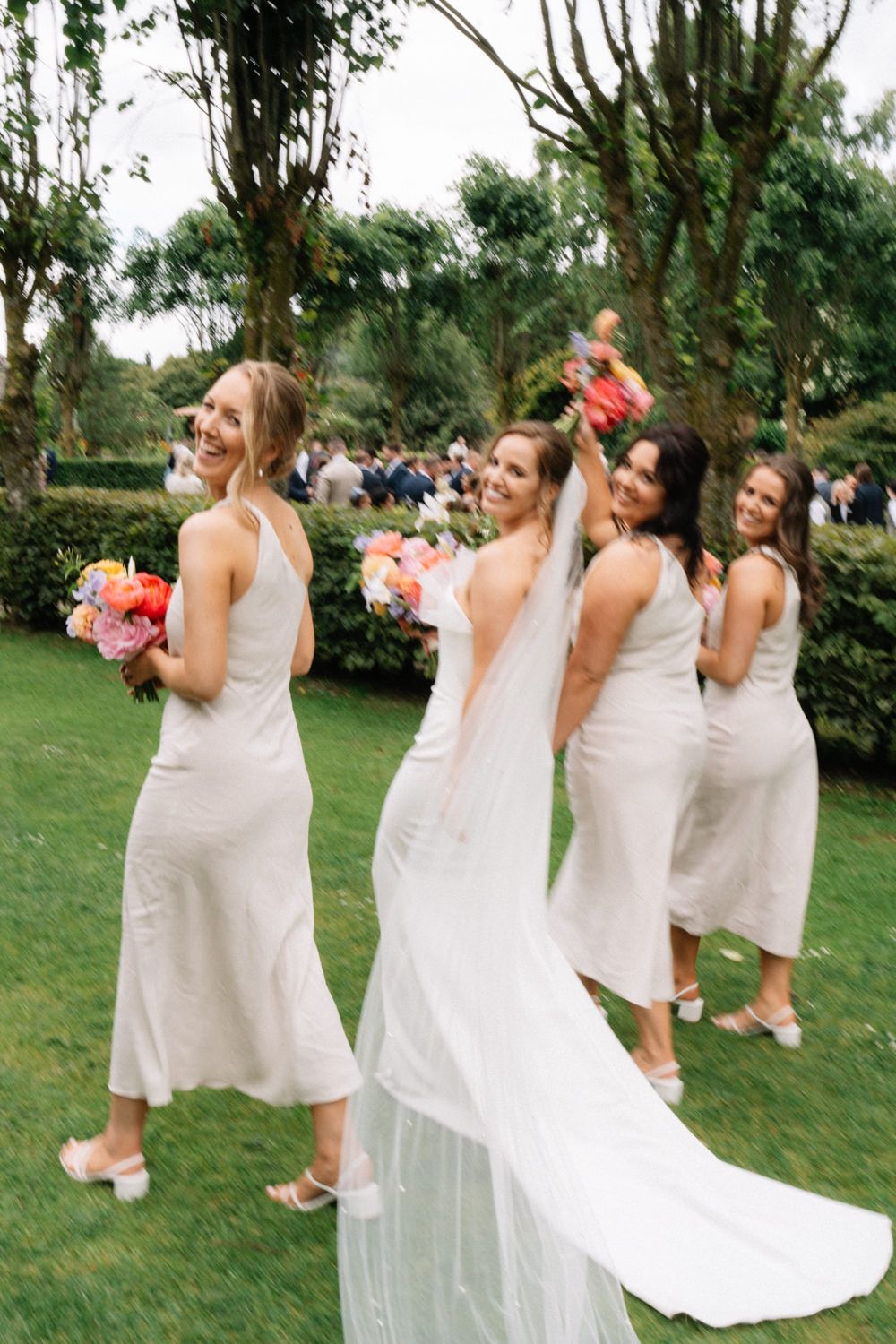 bridesmaids having fun with flowers Larchfield Estate Wedding Photos