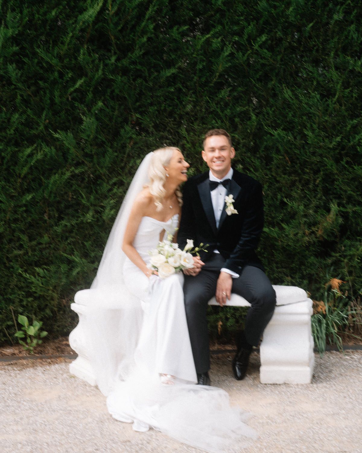 bride laughing at groom in the garden of Cabra castle Captured by a Cabra Castle Wedding Photographer