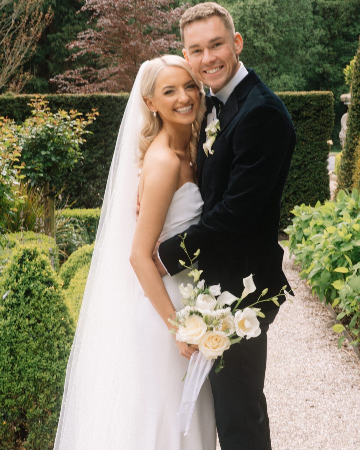 bride and groom hugging in the garden of Cabra castle Captured by a Cabra Castle Wedding Photographer