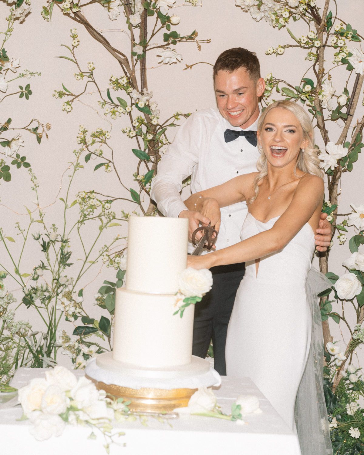 bride and groom cutting cake Captured by a Cabra Castle Wedding Photographer