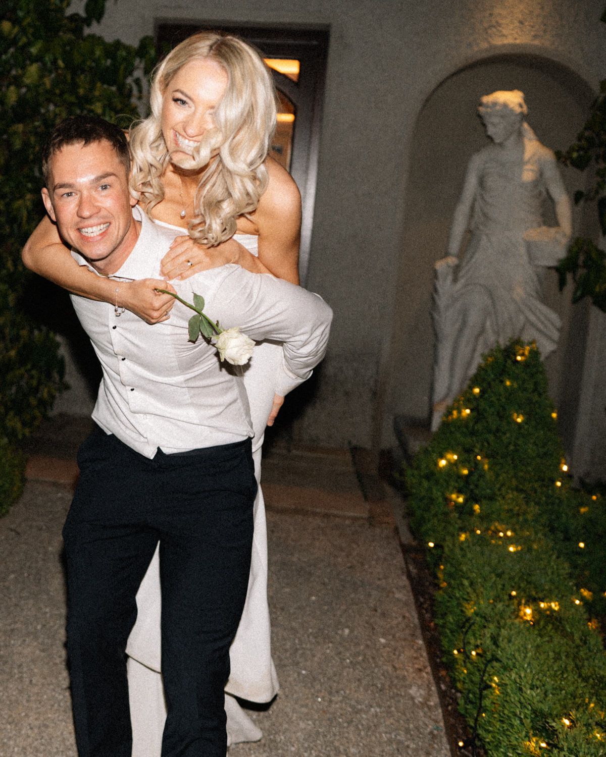 groom giving bride a piggy back Cabra Castle Wedding Photographer